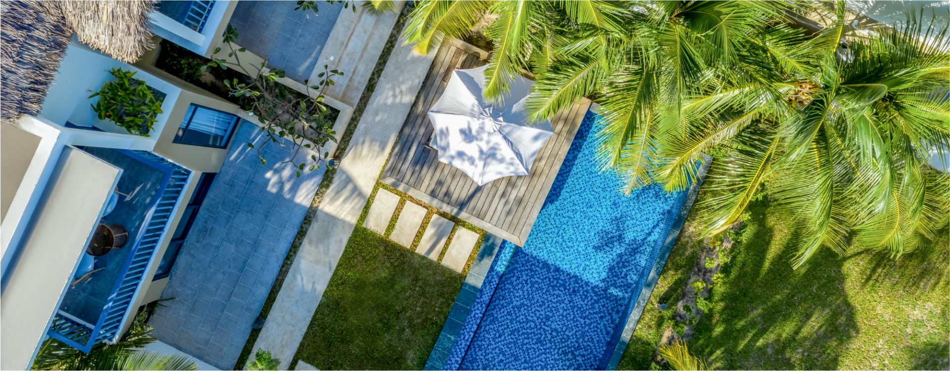 overhead exterior view of a private patio and pool next to a resort building at the New World Phu Quoc Resort 