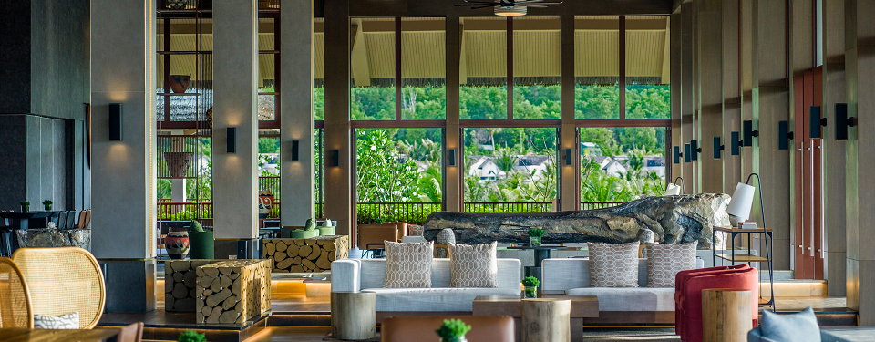The living room with sofa and sliding glass door leading to a private pool at the New World Phu Quoc Resort in Vietnam