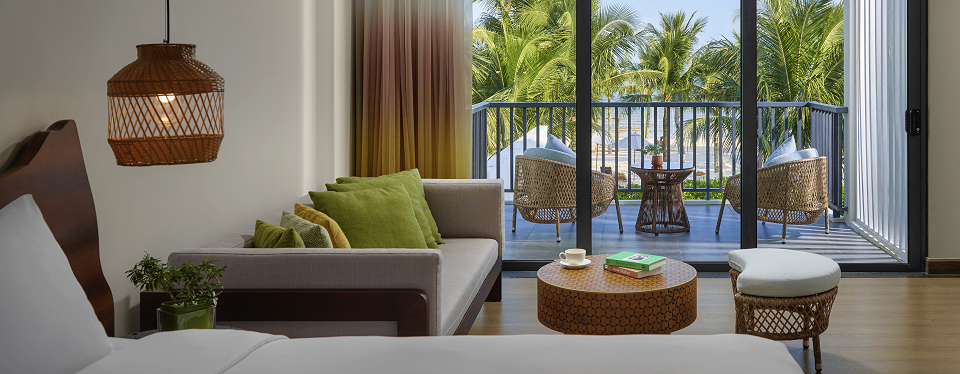 The living room with large space leading to beach view at the New World Phú Quốc Resort.