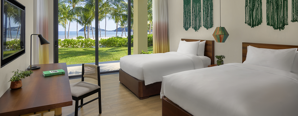 The bedroom with twin beds leading to beach at the New World Phu Quoc Resort.